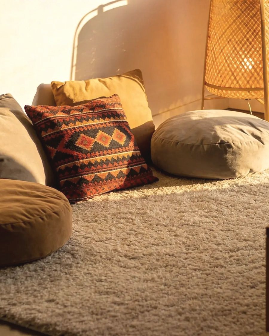 A cosy living space with handmade floor cushions and soft textile pieces