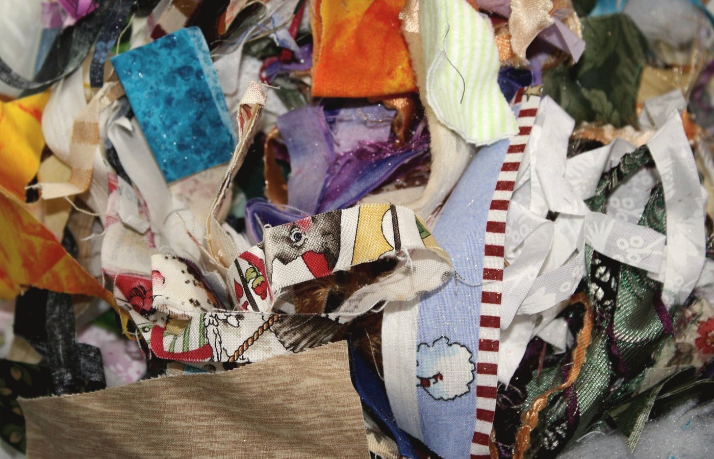 Mixed textile offcuts collected in the studio for reuse